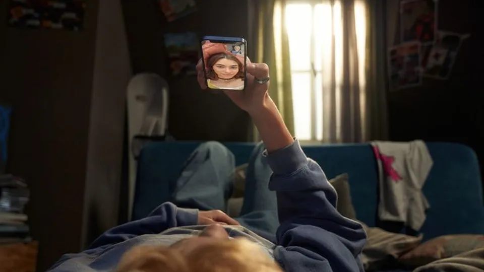 Lying back, phone held overhead