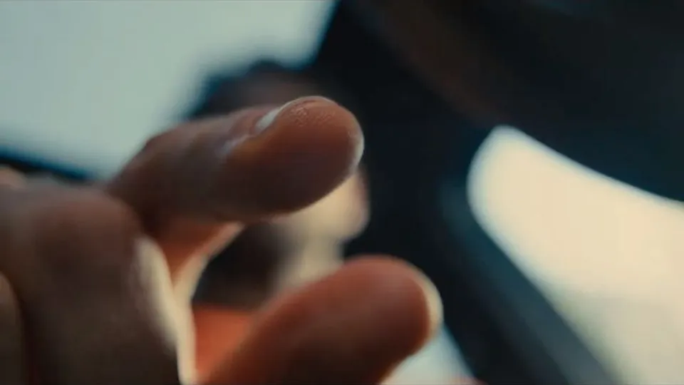 Close on a fingertip reaching in