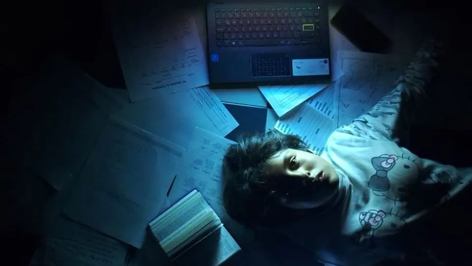 Overhead, lying on the floor between a laptop and a phone