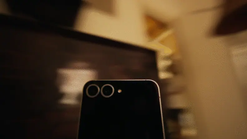 Camera behind a phone whips in on a blank stare